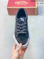 Top view showing the black toe area, contrast stitching, Vans tongue label, and skull-print laces.