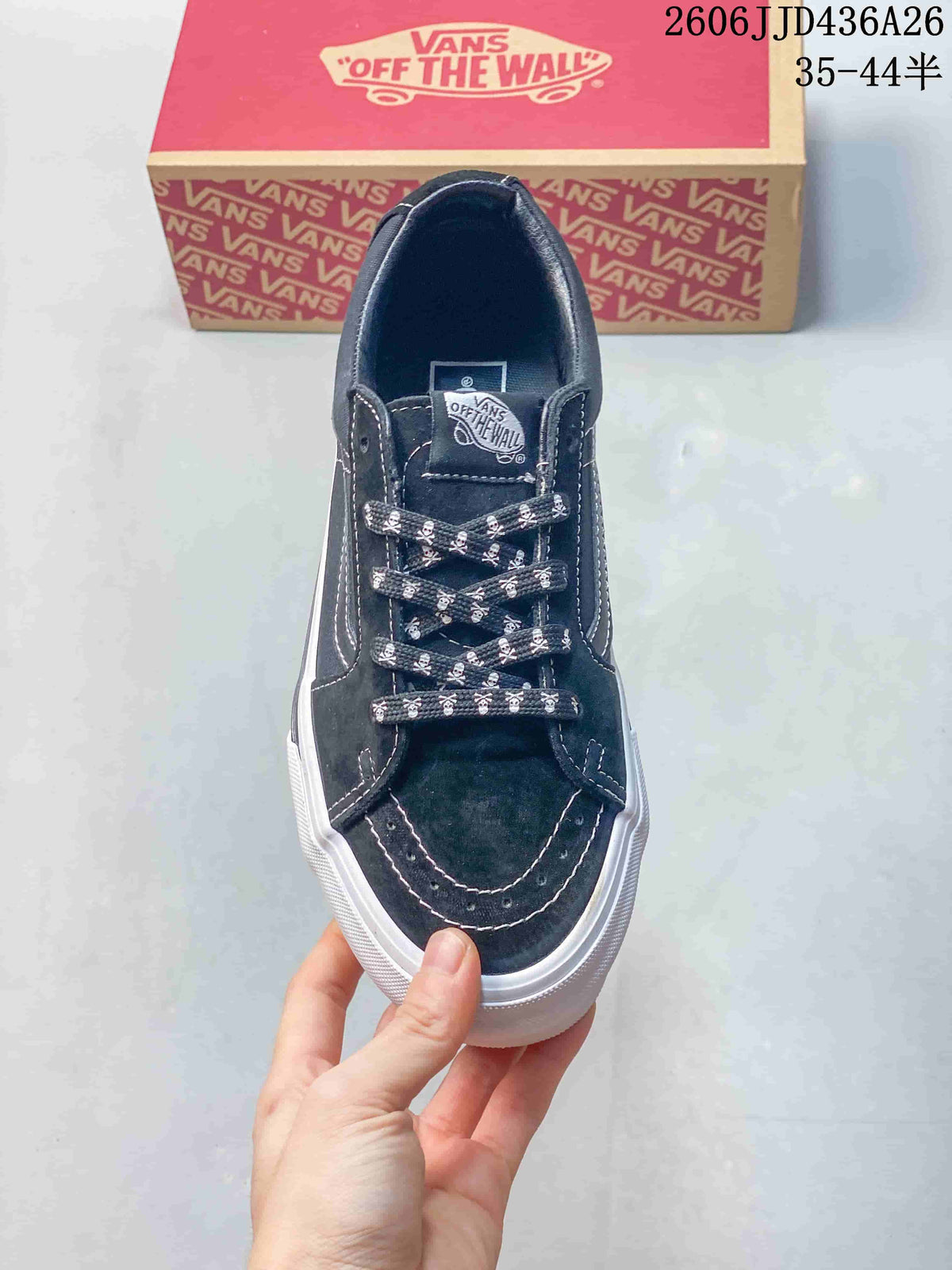 Top view showing the black toe area, contrast stitching, Vans tongue label, and skull-print laces.