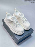 Pair of white ECCO lace-up sneakers with mesh panels and thick soles on a branded box.