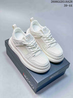 Pair of white ECCO lace-up sneakers with mesh panels and thick soles on a branded box.
