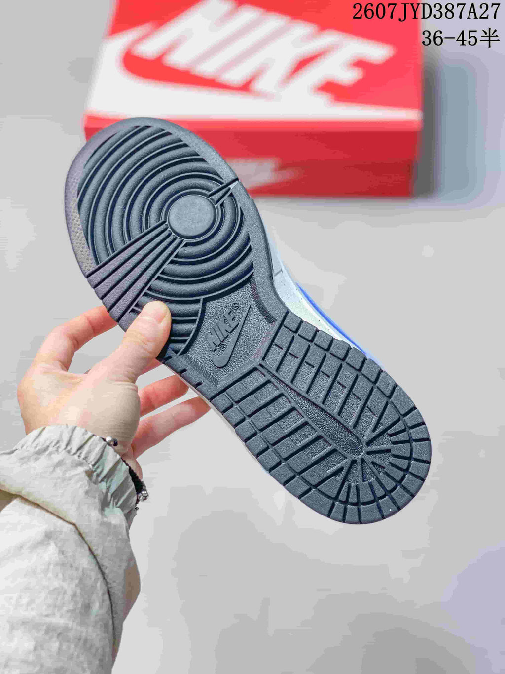 Close-up of the dark rubber outsole showing circular heel and patterned tread details.