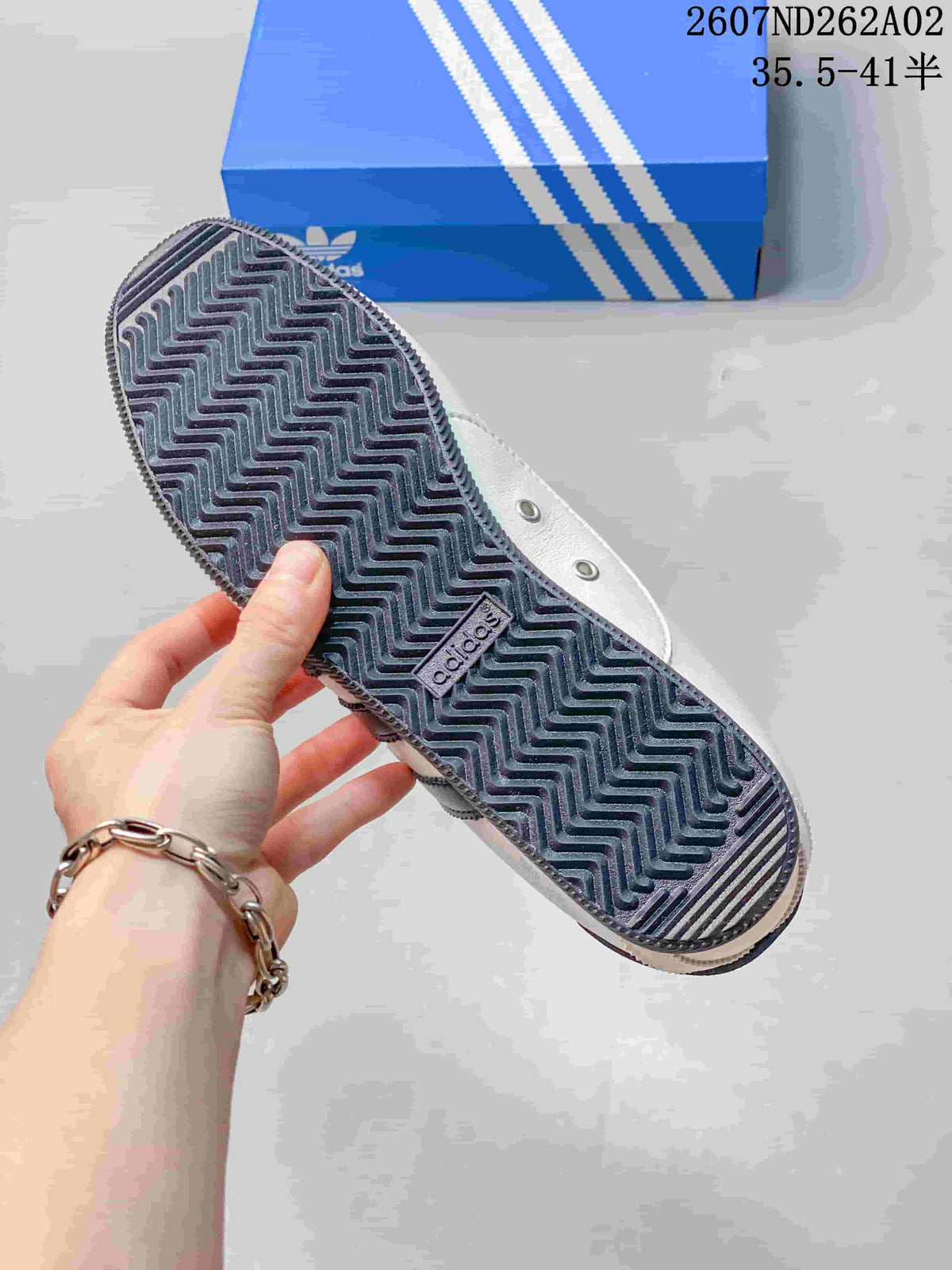 Close-up of the sneaker outsole showing a dark zigzag tread pattern