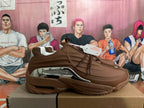 Side profile of a brown sneaker with metallic silver detailing and a chunky outsole