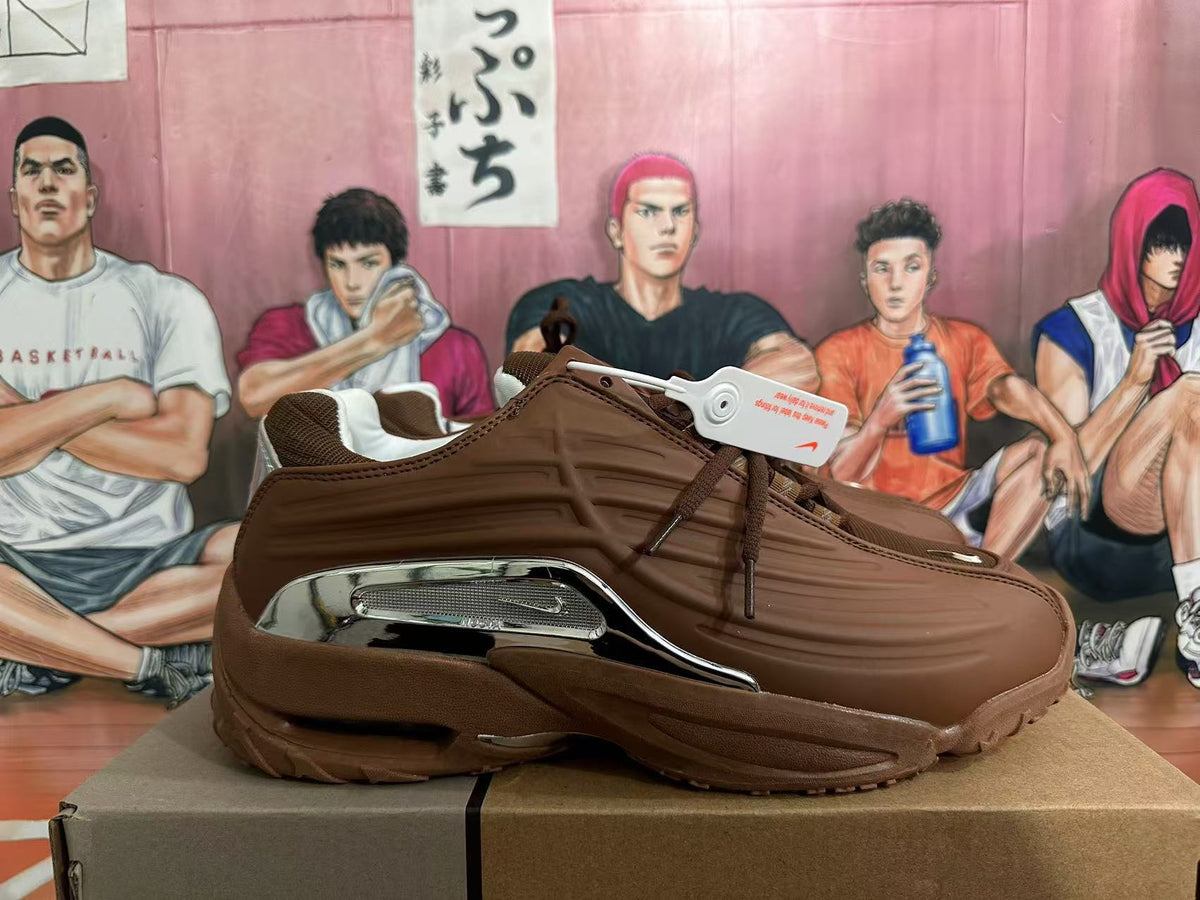 Side profile of a brown sneaker with metallic silver detailing and a chunky outsole