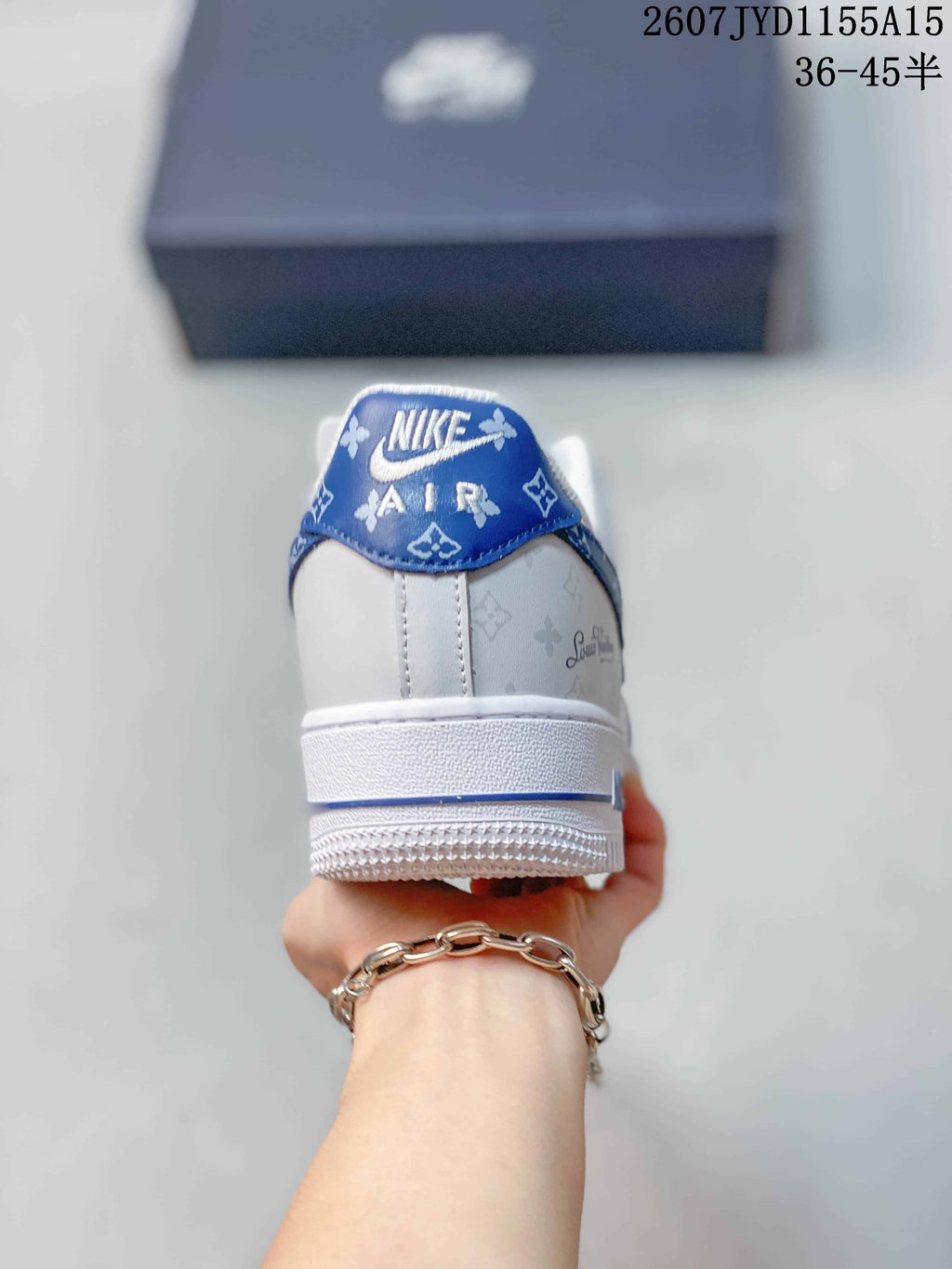 Rear view showing the blue patterned heel tab, white heel panel, and outsole.