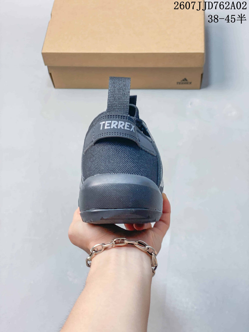 Rear view showing the heel pull tab and Terrex branding on a charcoal grey shoe.