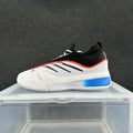 Side view of white, black, blue and orange Adidas low-top sneakers