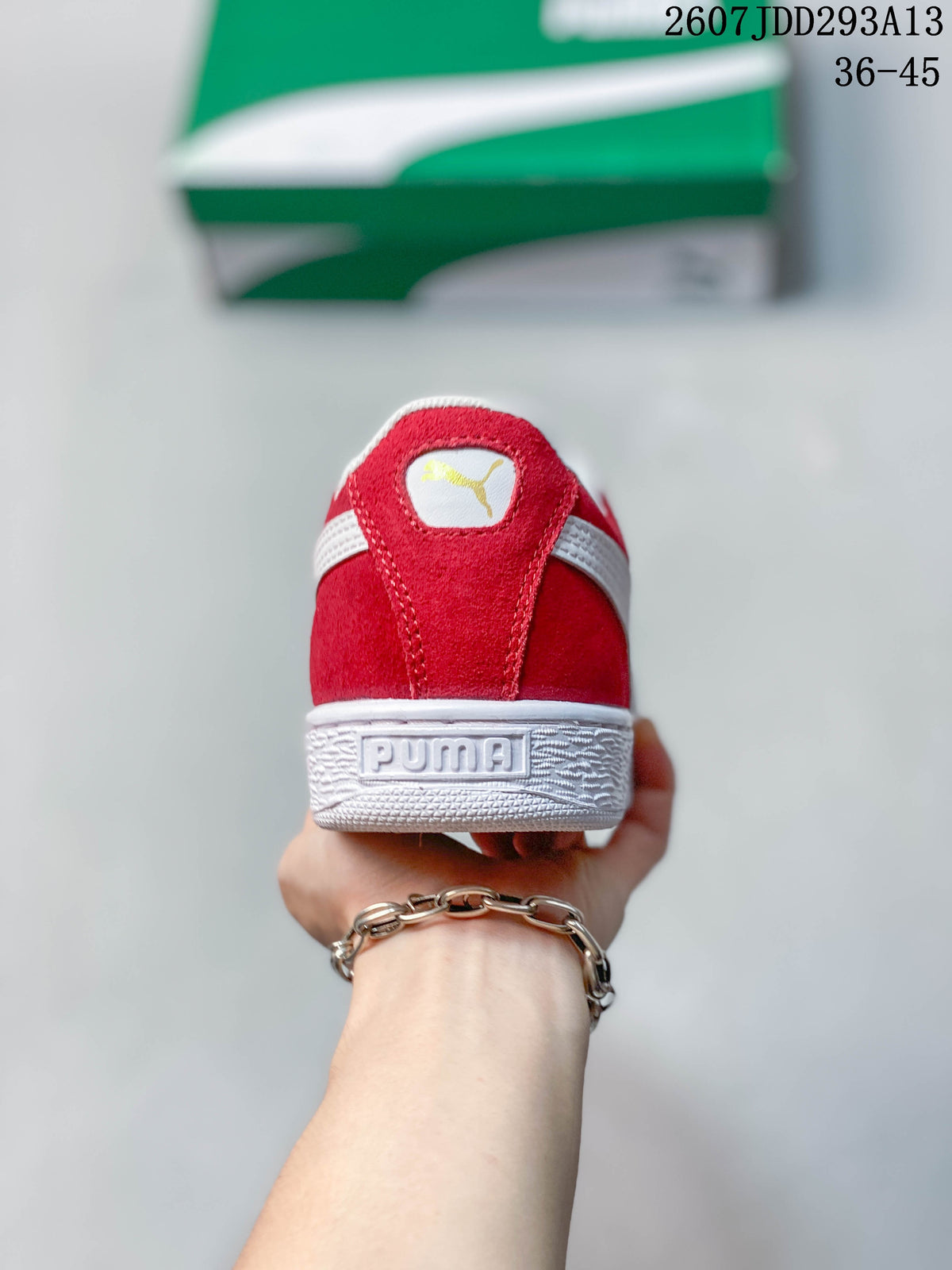 Rear view of the red sneaker showing the white collar stripe, PUMA heel branding, and textured white sole.