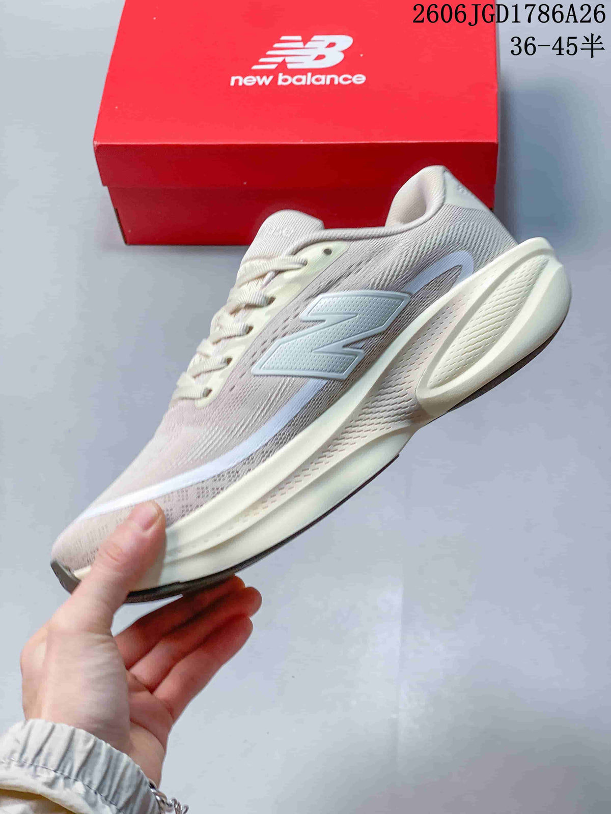 Side profile of a light neutral New Balance running shoe with a contrasting logo.