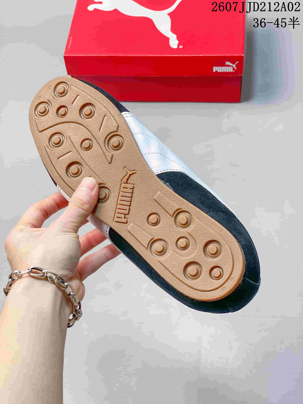Close-up of the gum-colored outsole with circular tread on a navy PUMA Tackle sneaker