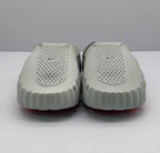 Front view of the pair of gray slide sandals showing the perforated uppers and rounded sculpted toes.