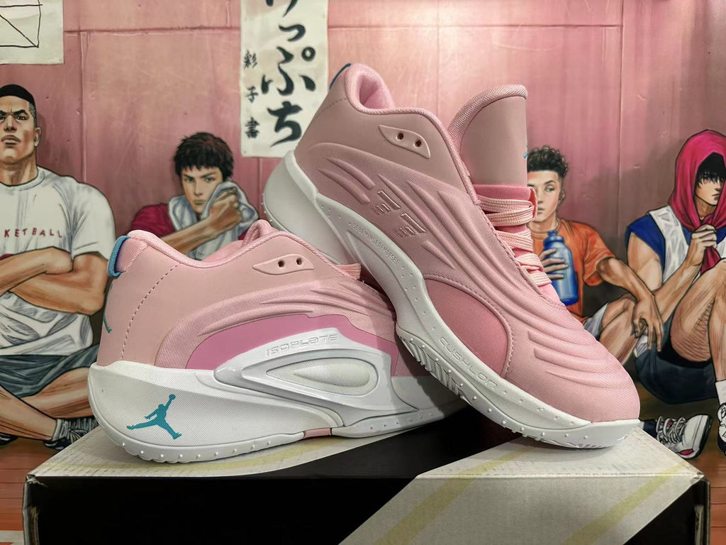Angled side view of pink and white basketball shoes showing layered upper and outsole