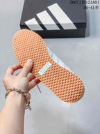 Textured gum-colored outsole on an adidas JOG 2.0 sneaker