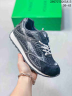 Angled side view of the black and white sneaker showing the lace-up upper, contrast side detailing, and textured outsole.