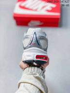 Rear view of a Nike Air Max Moto 2K sneaker showing the padded heel, layered upper, and red outsole detail.
