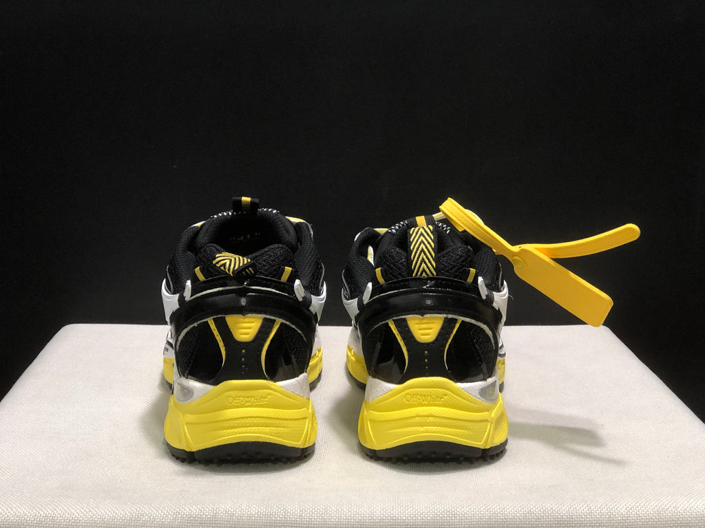 Rear view showing black padded collars, yellow heel details, and textured yellow midsoles.