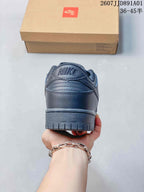 Rear view of a dark gray Nike Dunk Low sneaker