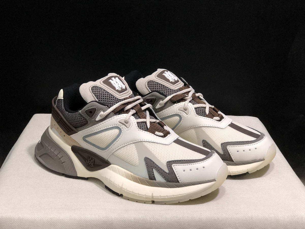 Pair of AMIRI MA Runner sneakers shown from a front three-quarter angle.
