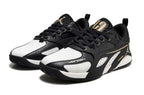 Pair of black and white Jordan Heir shoes with gold-tone accents