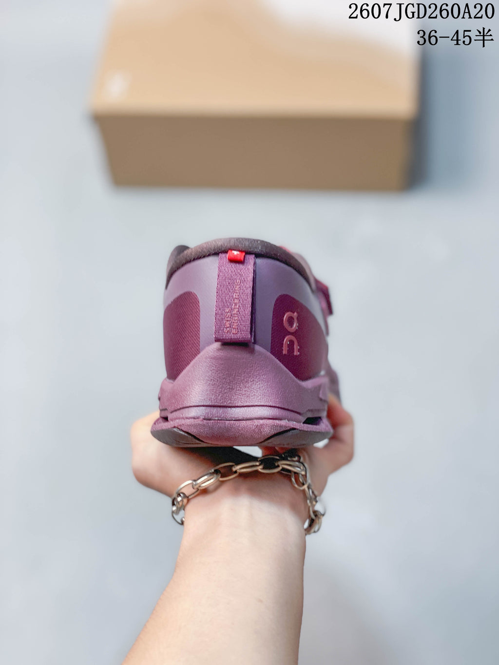 Rear view of the plum-purple sneaker showing the padded heel collar and branded heel details.
