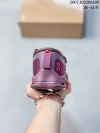 Rear view of the plum-purple sneaker showing the padded heel collar and branded heel details.