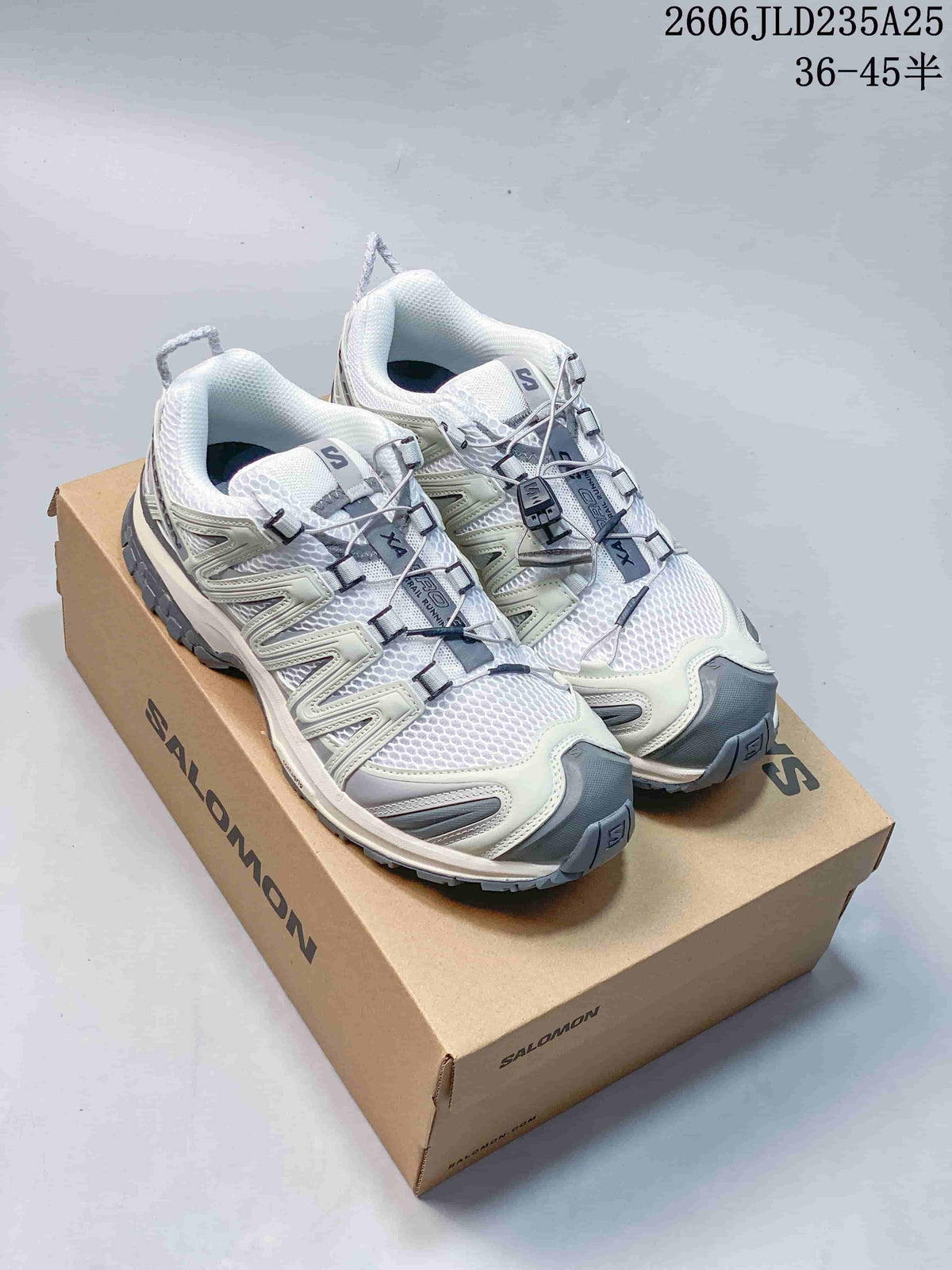 Pair of white and gray Salomon XA Pro 3D trail shoes on a box