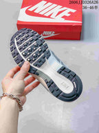 Close-up of the patterned outsole on a silver and white Nike P-6000 sneaker