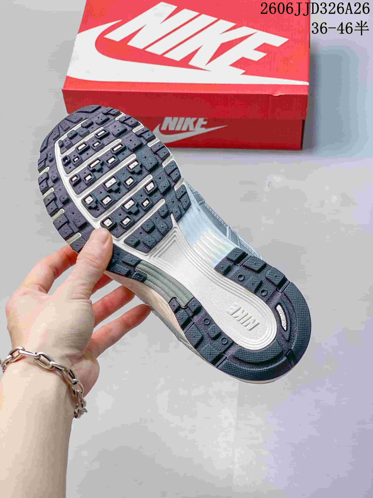 Close-up of the patterned outsole on a silver and white Nike P-6000 sneaker