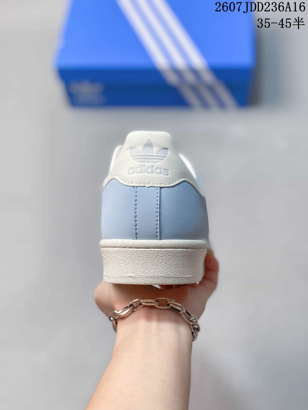 Rear view showing the light blue heel, white collar, and adidas branding.