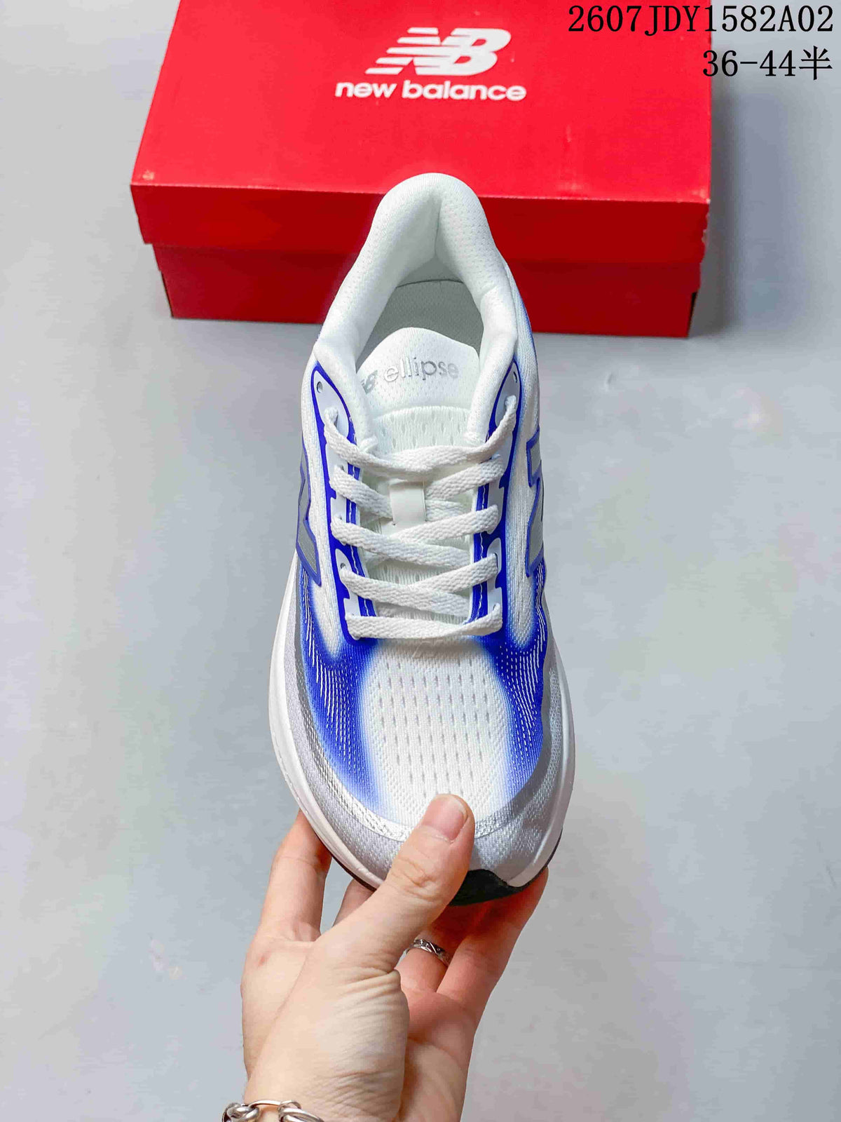 Top view of a white and blue lace-up New Balance running shoe