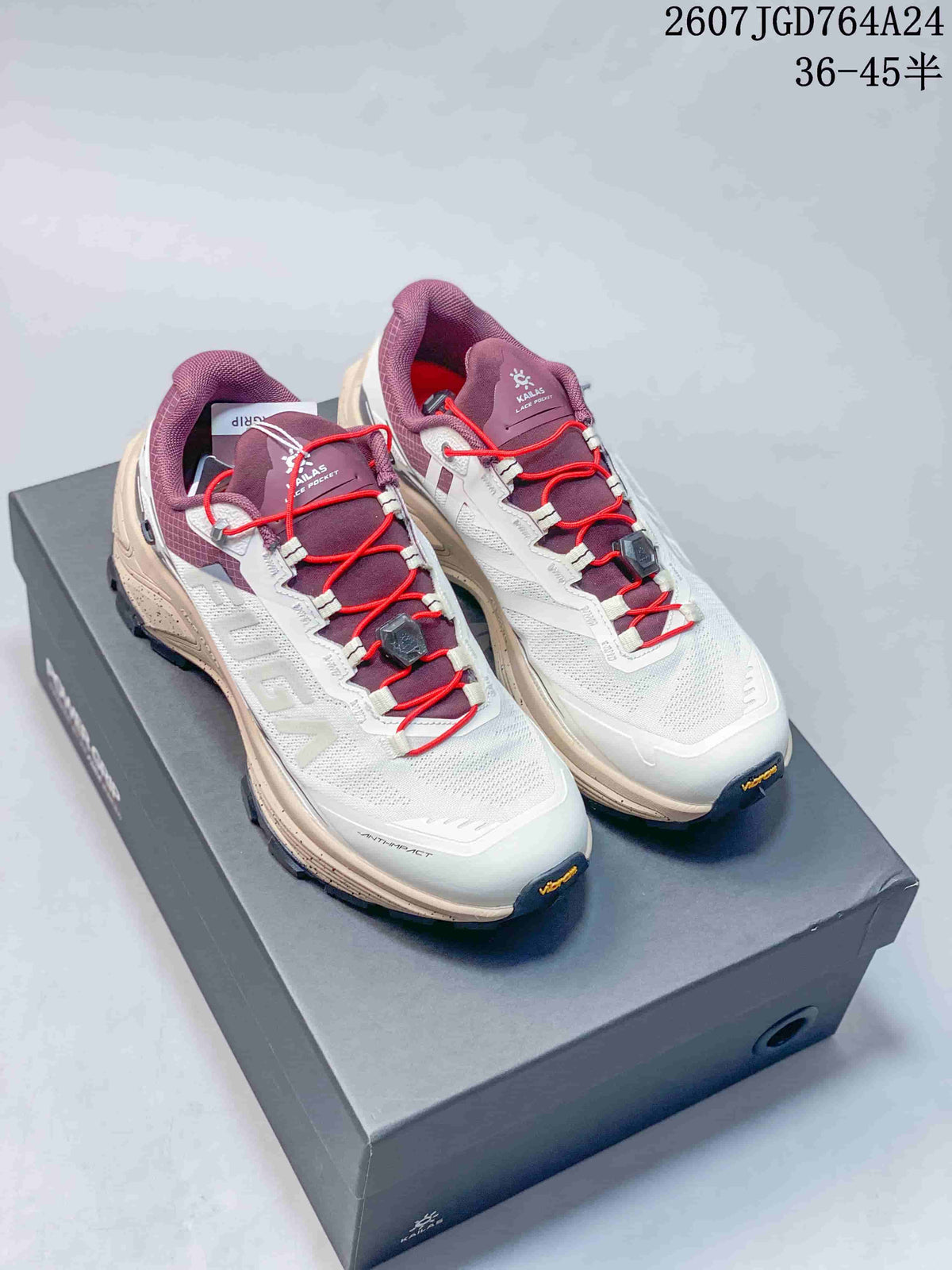Pair of Kailas FUGA EX3 trail running shoes displayed on a shoebox, showing the white, purple and red colorway.
