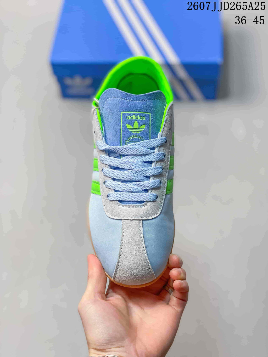 Top view showing the blue laces, light contrasting panels and adidas tongue branding.
