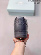 Rear view of a black low-top sneaker showing the padded heel, tonal Air branding and textured outsole.