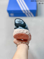 Rear view of the sneaker showing the padded collar, textured cream midsole, and pink outsole.