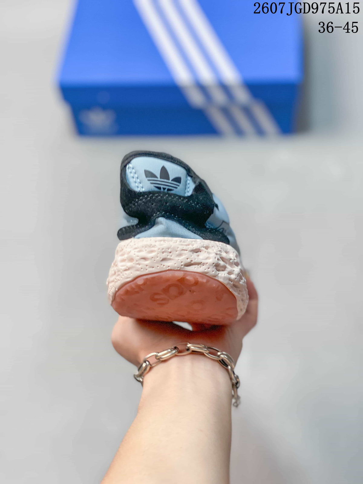Rear view of the sneaker showing the padded collar, textured cream midsole, and pink outsole.