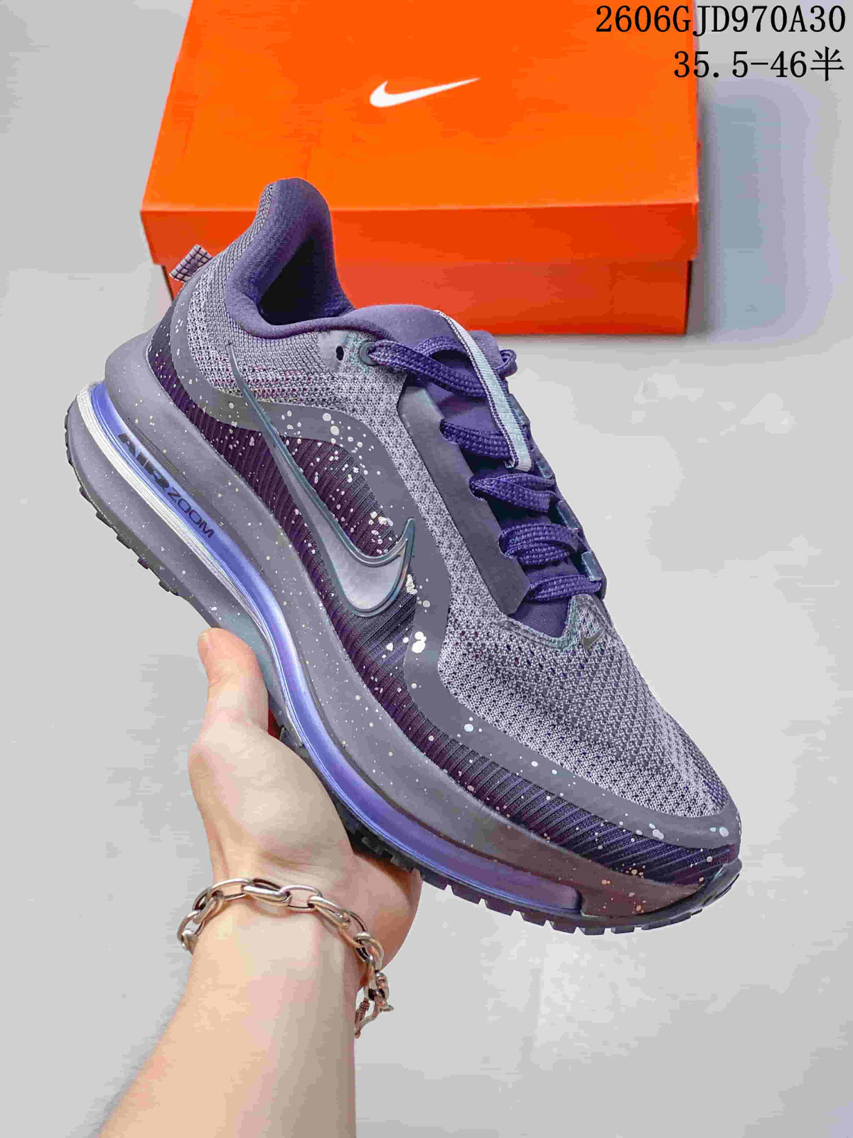 Gray and purple Nike Air Zoom Pegasus Premium sneaker with speckled overlays and a visible midsole unit.