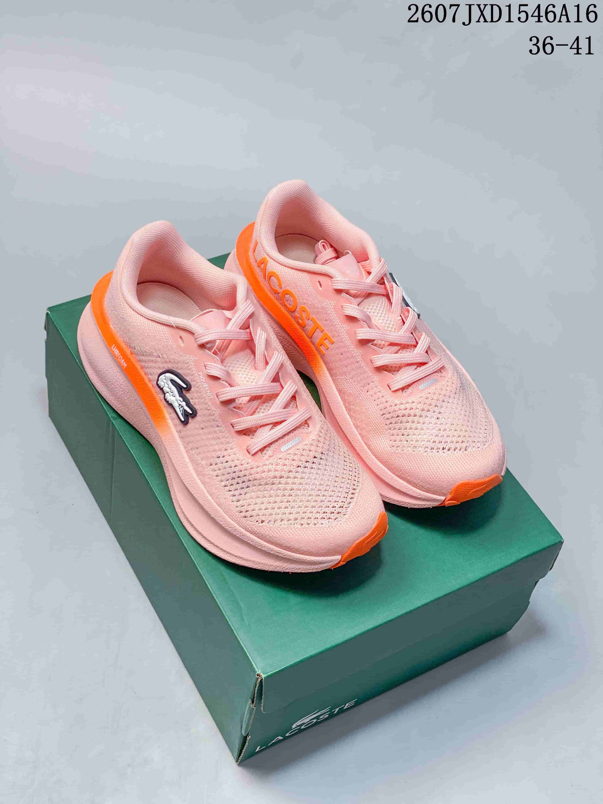 Pair of pink and orange Lacoste Neo Run sneakers displayed on a green shoebox.