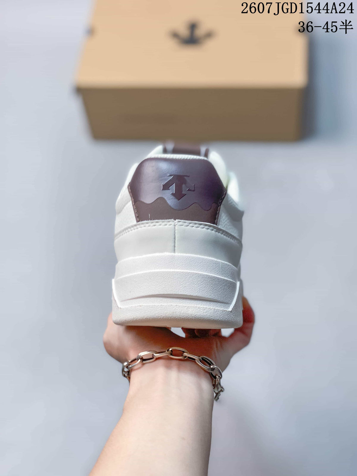 Rear view of the white sneaker showing the padded heel, layered white sole, and brown heel accent.