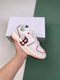 White low-top MLB sneakers with red trim, red outsole accents, and a large side letter emblem, shown with a matching box.