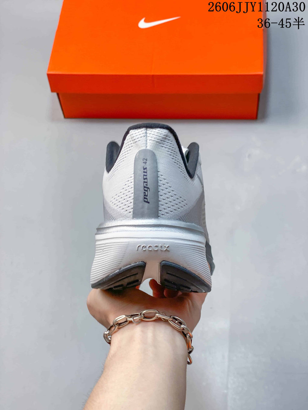 Rear view of a white and gray Nike Pegasus 42 shoe