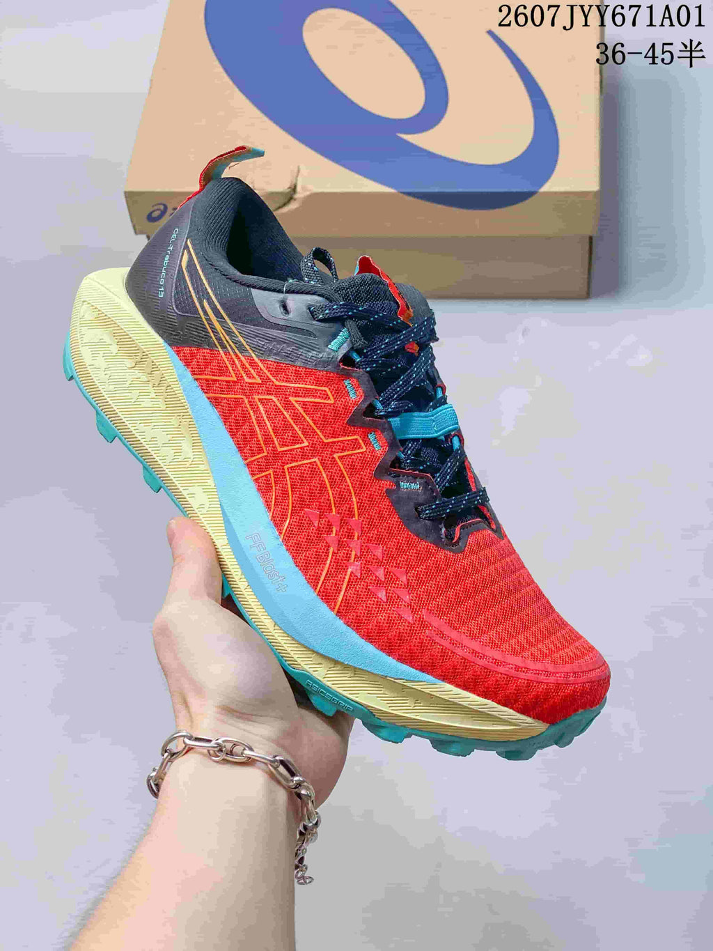 Red ASICS GEL-TRABUCO 13 trail shoe with blue and yellow-green accents