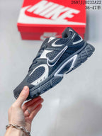 Side profile of a black and white Nike V5 RNR sneaker showing the mesh upper, contrast overlays, side branding, and chunky outsole.