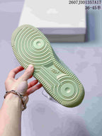 Close view of the pale green rubber outsole showing circular traction patterns and Air branding.