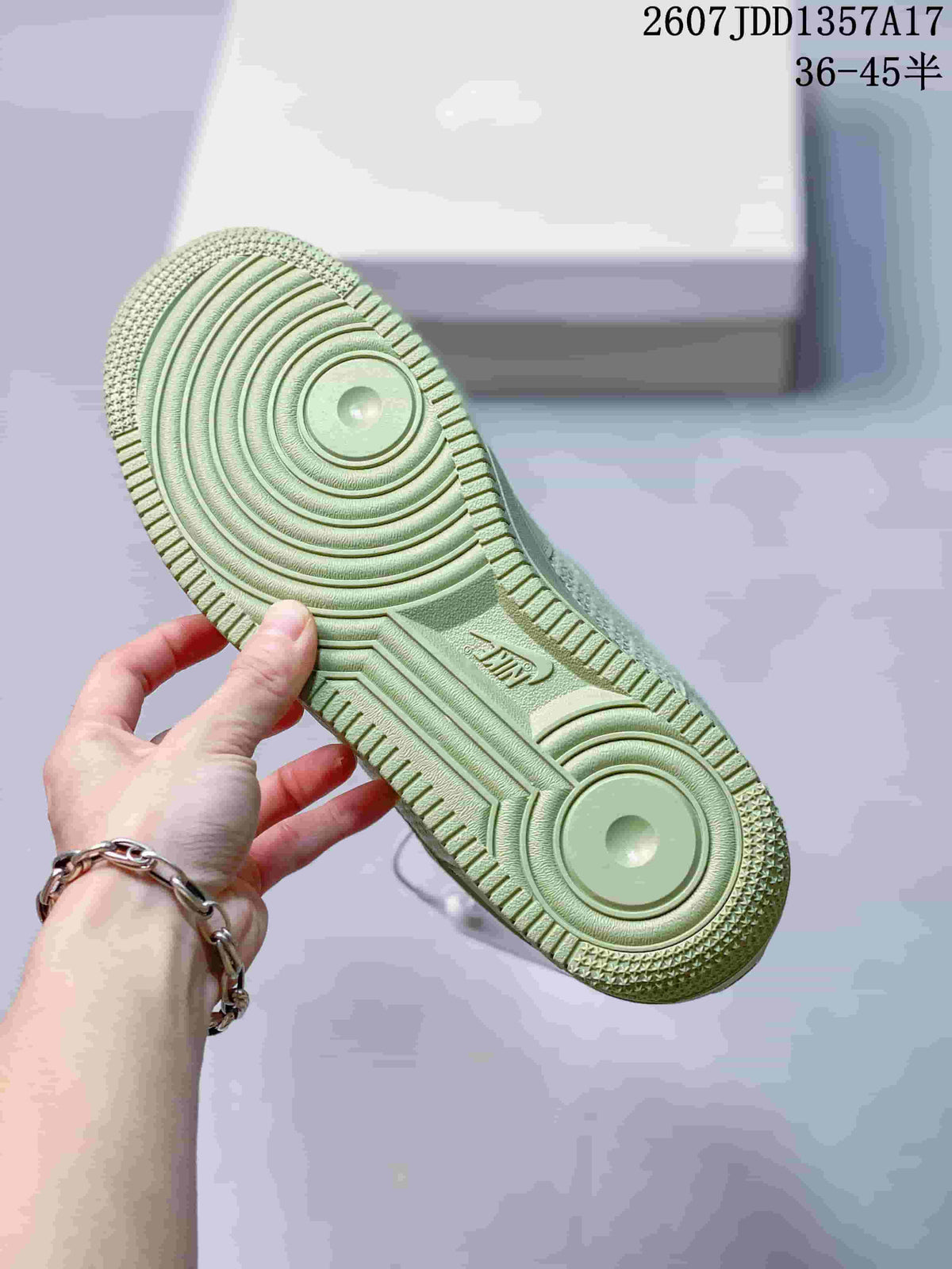 Close view of the pale green rubber outsole showing circular traction patterns and Air branding.