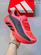 Angled side view highlighting the pink upper, dark panels, and textured sole