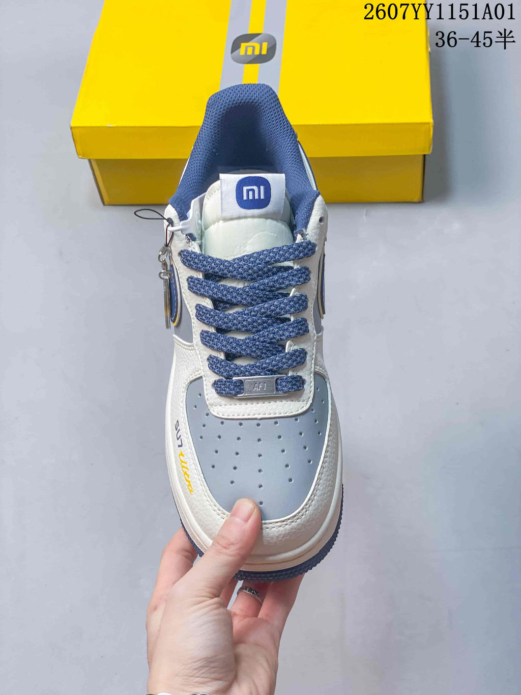 Front view showing blue laces, a blue-gray perforated toe panel, and Xiaomi-branded tongue detail.