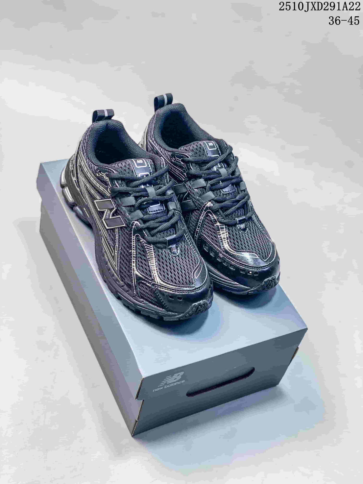 Pair of dark grey and silver New Balance 1906AD sneakers on a shoe box