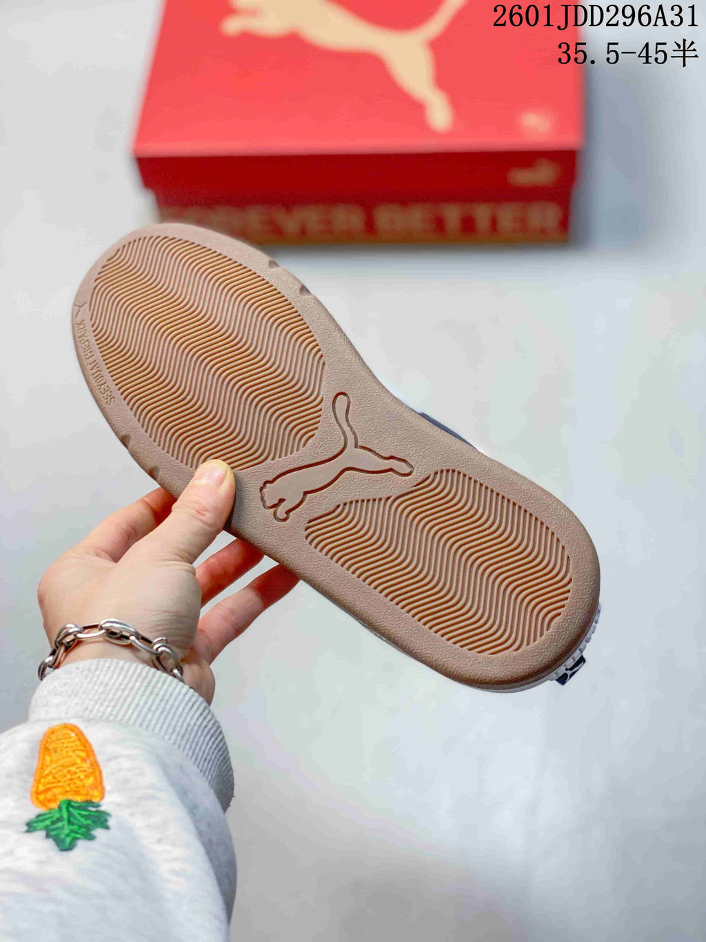Bottom view showing the textured tan outsole and central PUMA logo.
