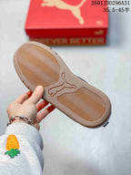 Bottom view showing the textured tan outsole and central PUMA logo.