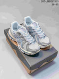 Pair of pale silver and blue ASICS Gel-Kayano 12.1 sneakers on a shoe box